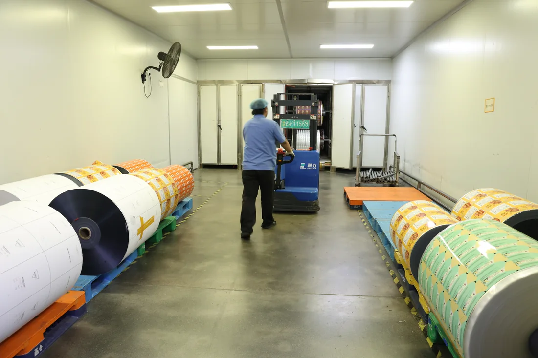 Laminated film rolls in a curing room at a partner manufacturing facility